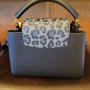 Capucines BB shoulder straps bag. Black with leather animal prints trim.